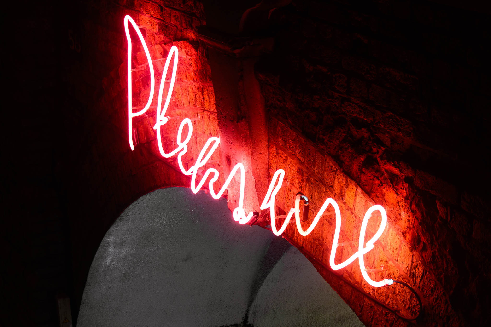 Neon "Pleasure" sign at London Vauxhall